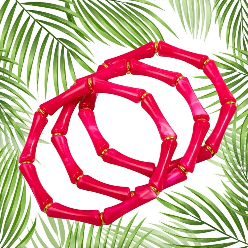 Three hot pink faux, bamboo stacking bracelets with gold accents. Tiki p…